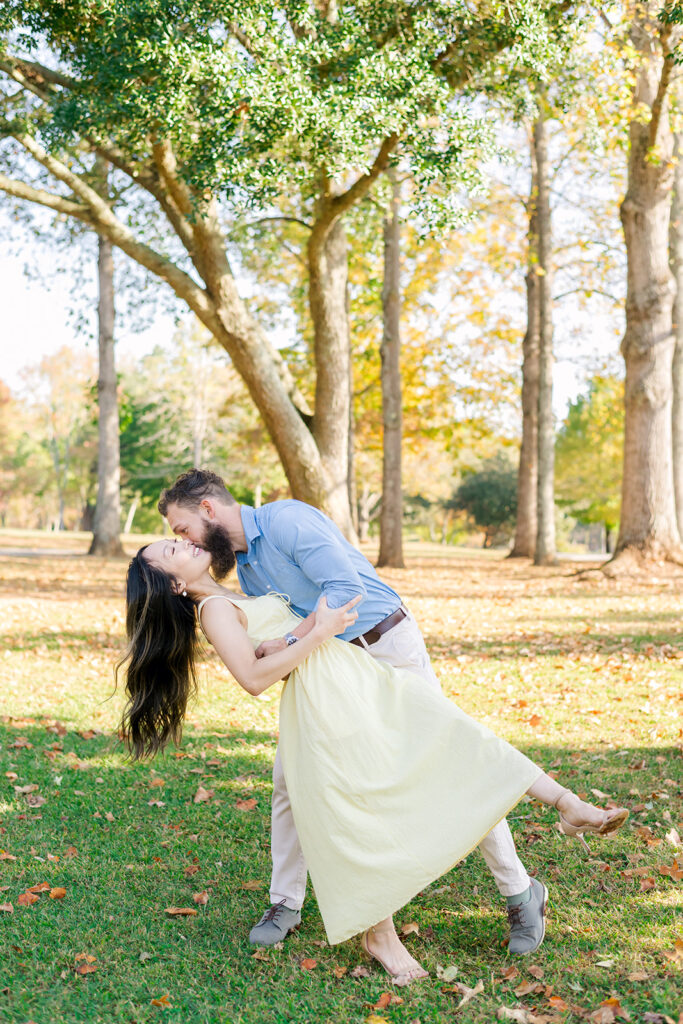 Man in blue collared shirt dips woman in yellow dress