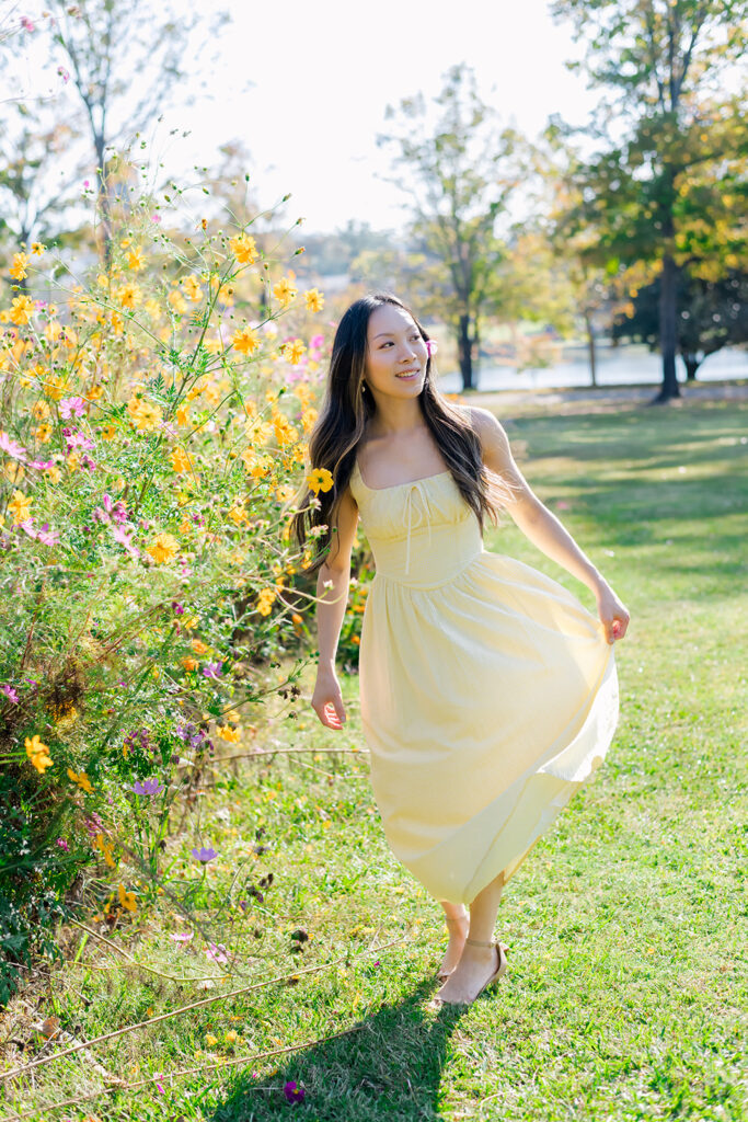 Woman in yellow dress walking in flower field