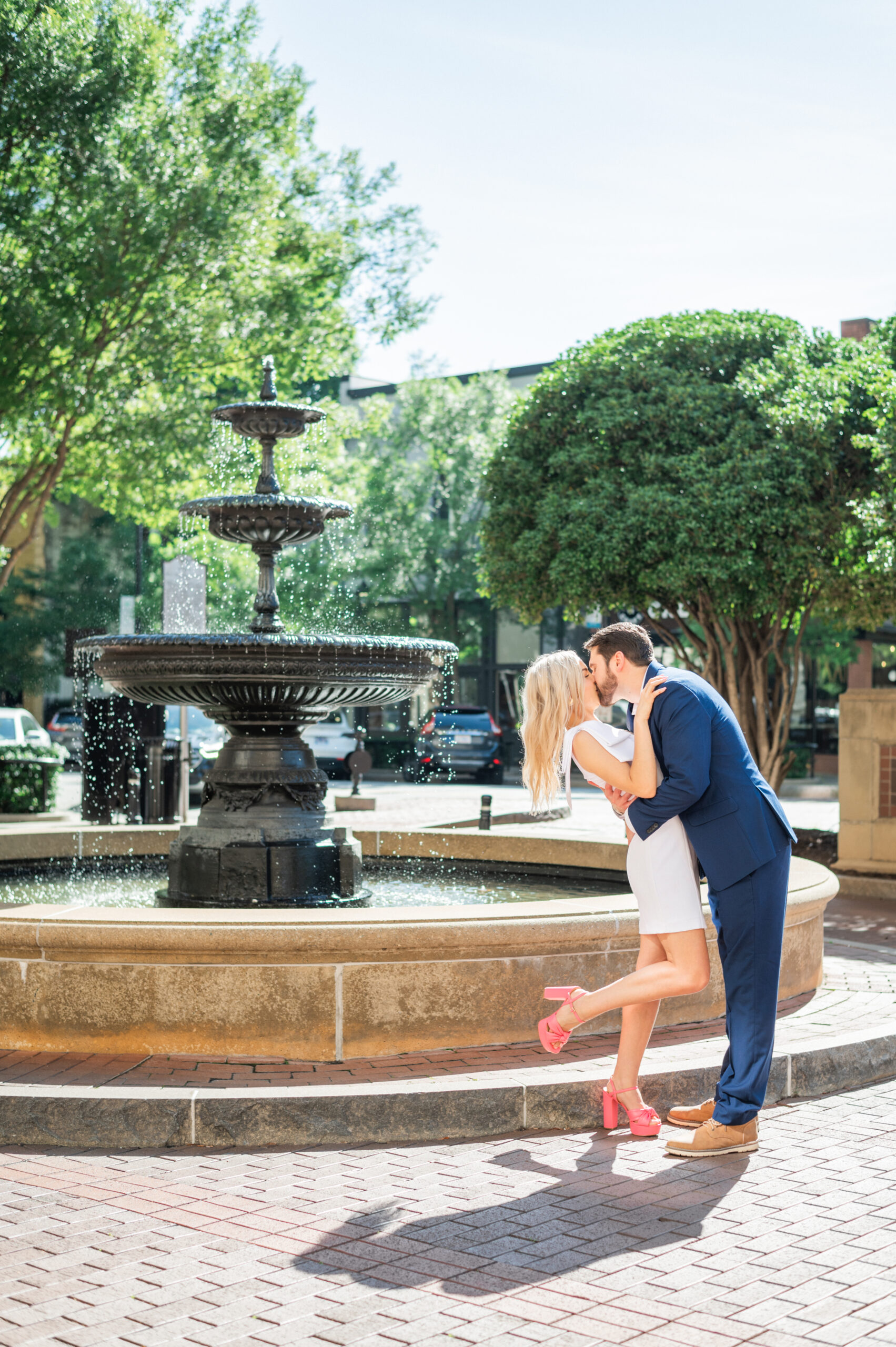 Couple kissing by fountain in downtown Greenville, SC