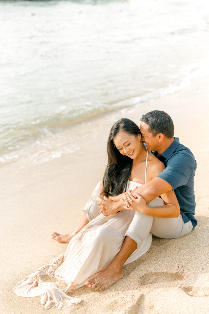Sullivan’s Island proposal couple sitting in sand