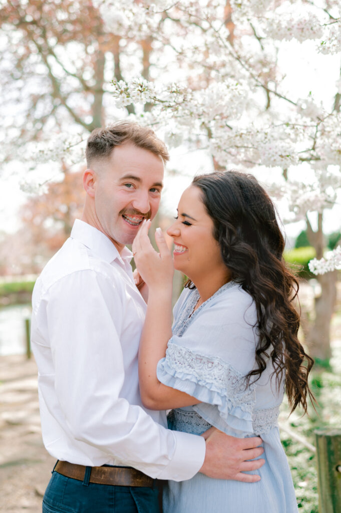 Couple sharing a laugh and girl covering mouth at Furman University in Greenville SC