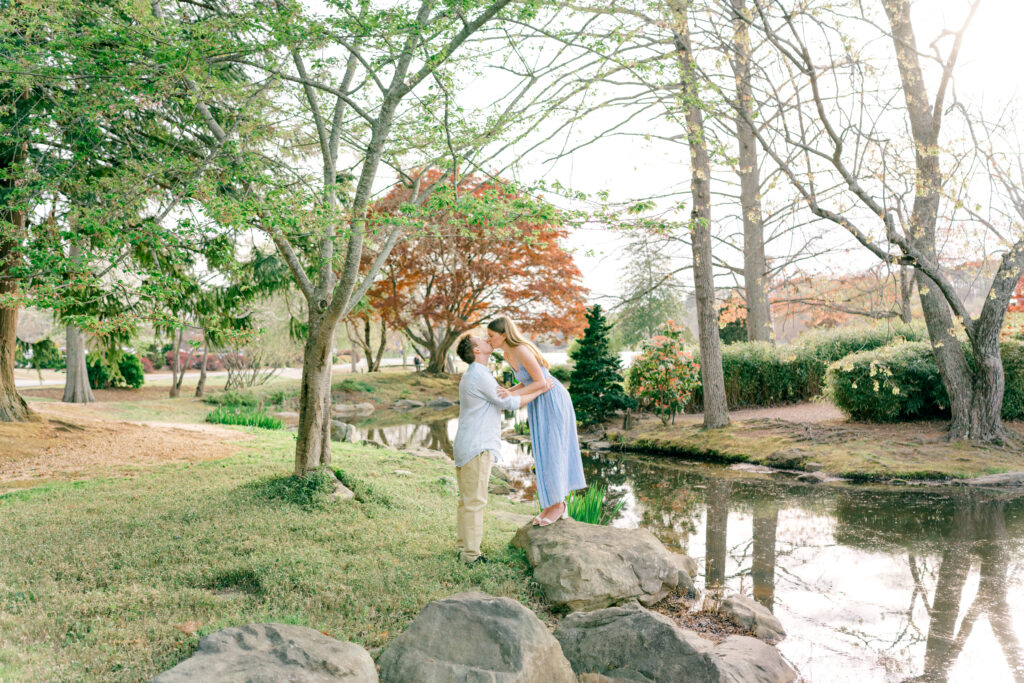 engagement session with girl kissing fiance at the Asia Garden at Furman Unversity 