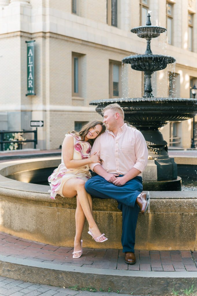 Downtown Greenville engagement photos with historic architecture and fountain near the Westin Poinsett