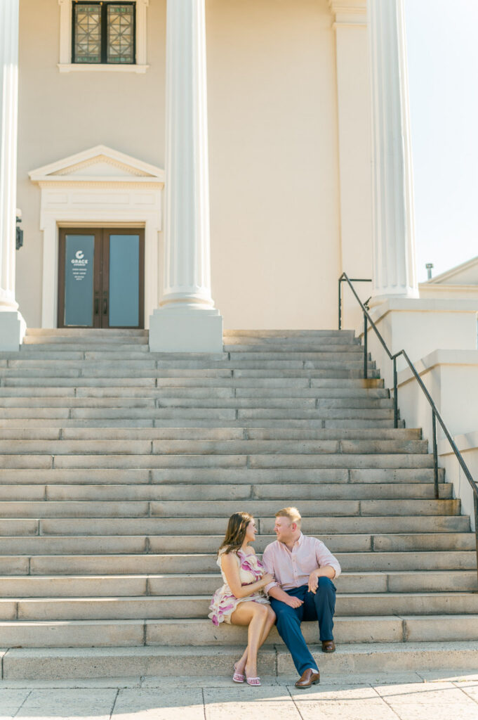 Spring engagement session sitting at Grace Church Downtown steps in Downtown Greenville near Westin Poinsett