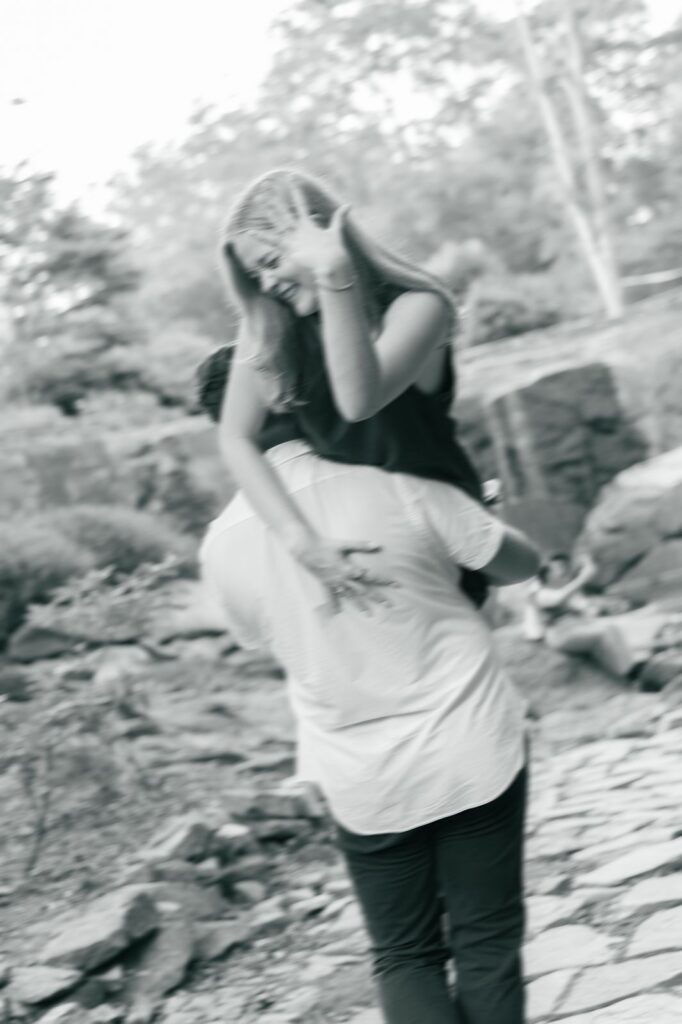 Motion blur image of fiance with ring at garden proposal
