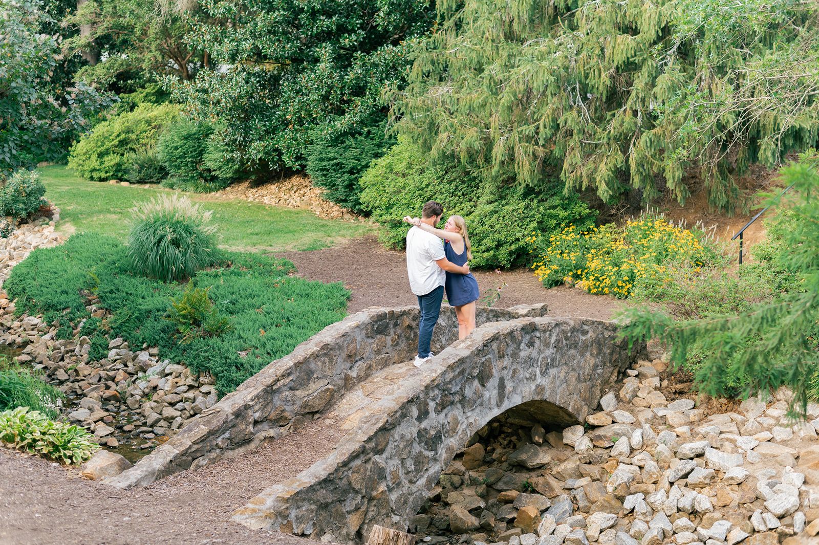 Couple Standing After Garden Proposal at Rock Quarry Garden Stone Bridge