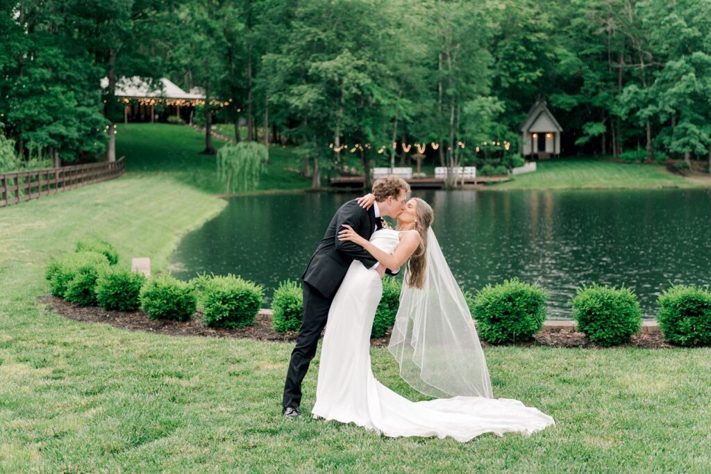 Couple kissing for portraits at their outdoor wedding venue in Greenville SC