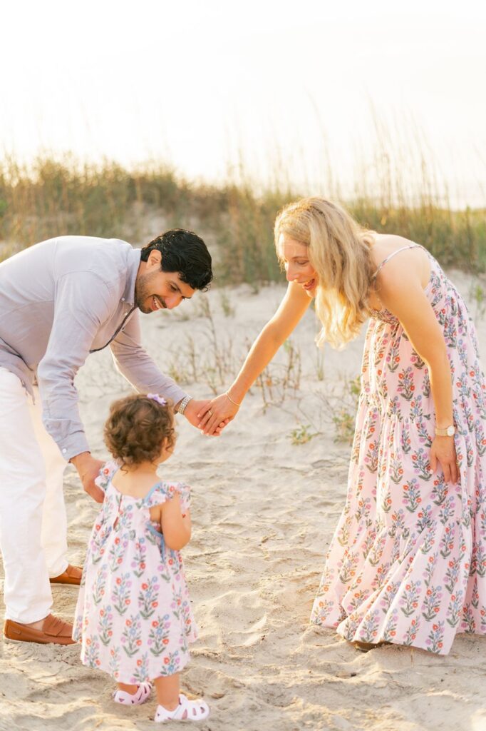 Family play ring around the rosie during family beach session