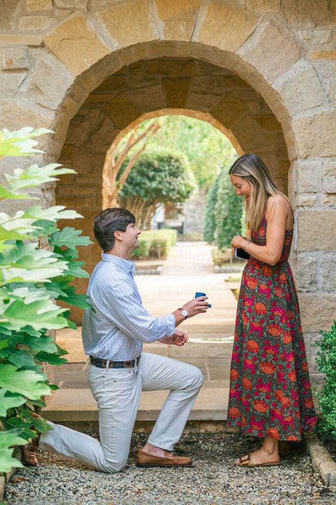 Guy proposing at the courtyard at Founder's Hall at The Reserve at Lake Keowee